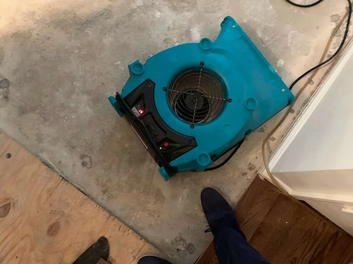 Air mover drying subfloor during Commercial Water Damage Restoration in New Franklin